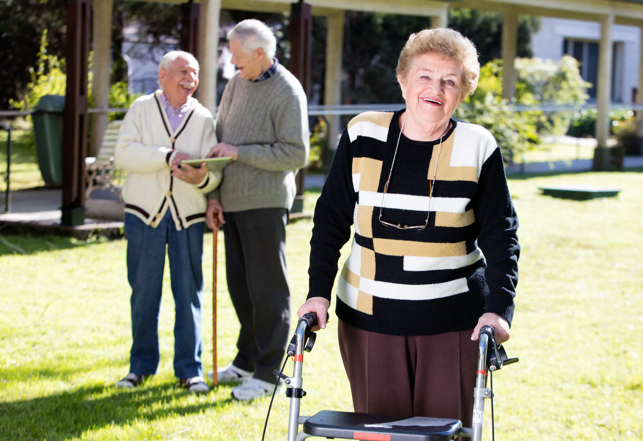 Happy retired woman with walker in a rehab clinic outdoor Happy retired woman with walker in a rehab clinic outdoor